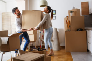 couple moving boxes into new apartment